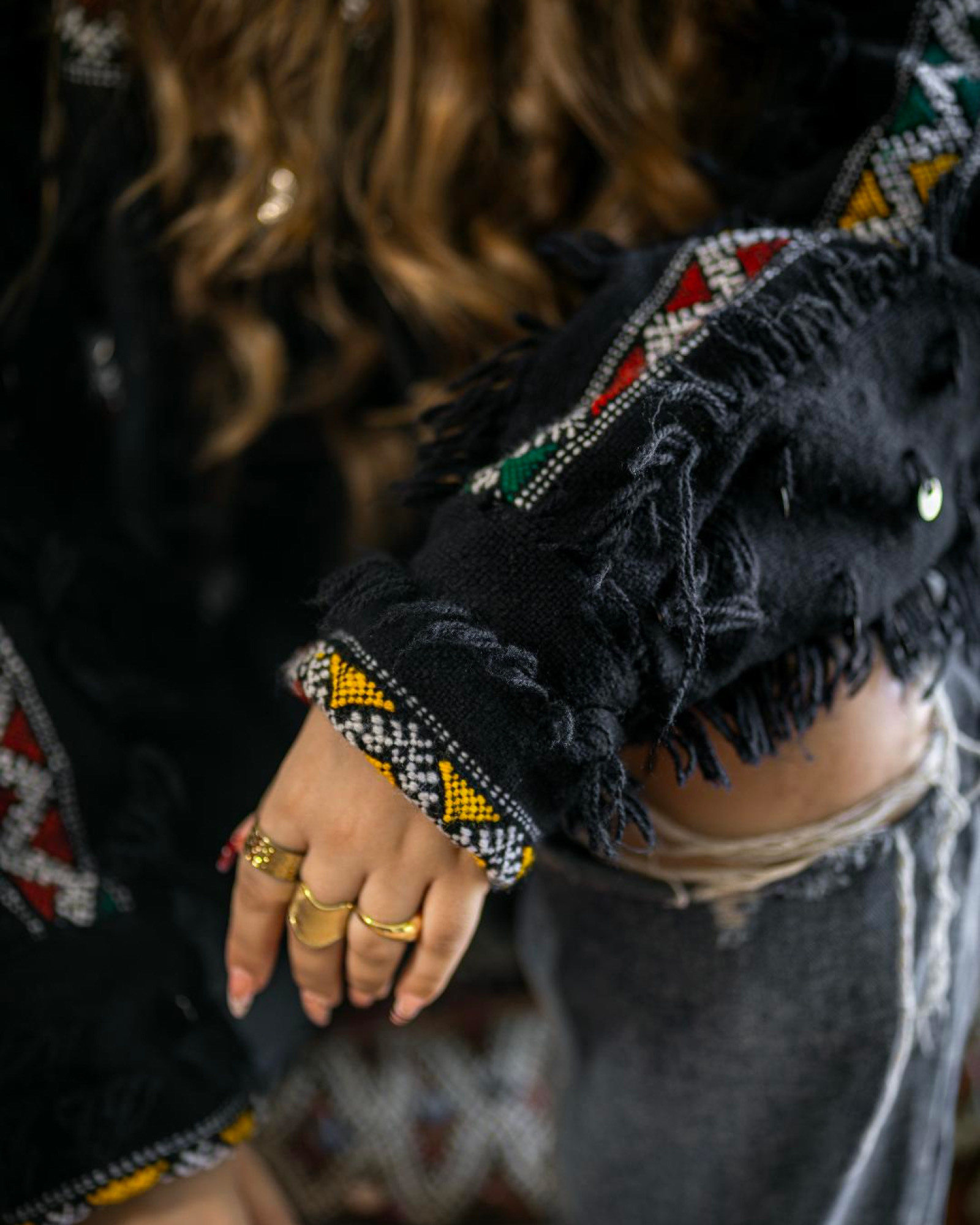Close-up of the black jacket sleeve with beaded Amazigh trim